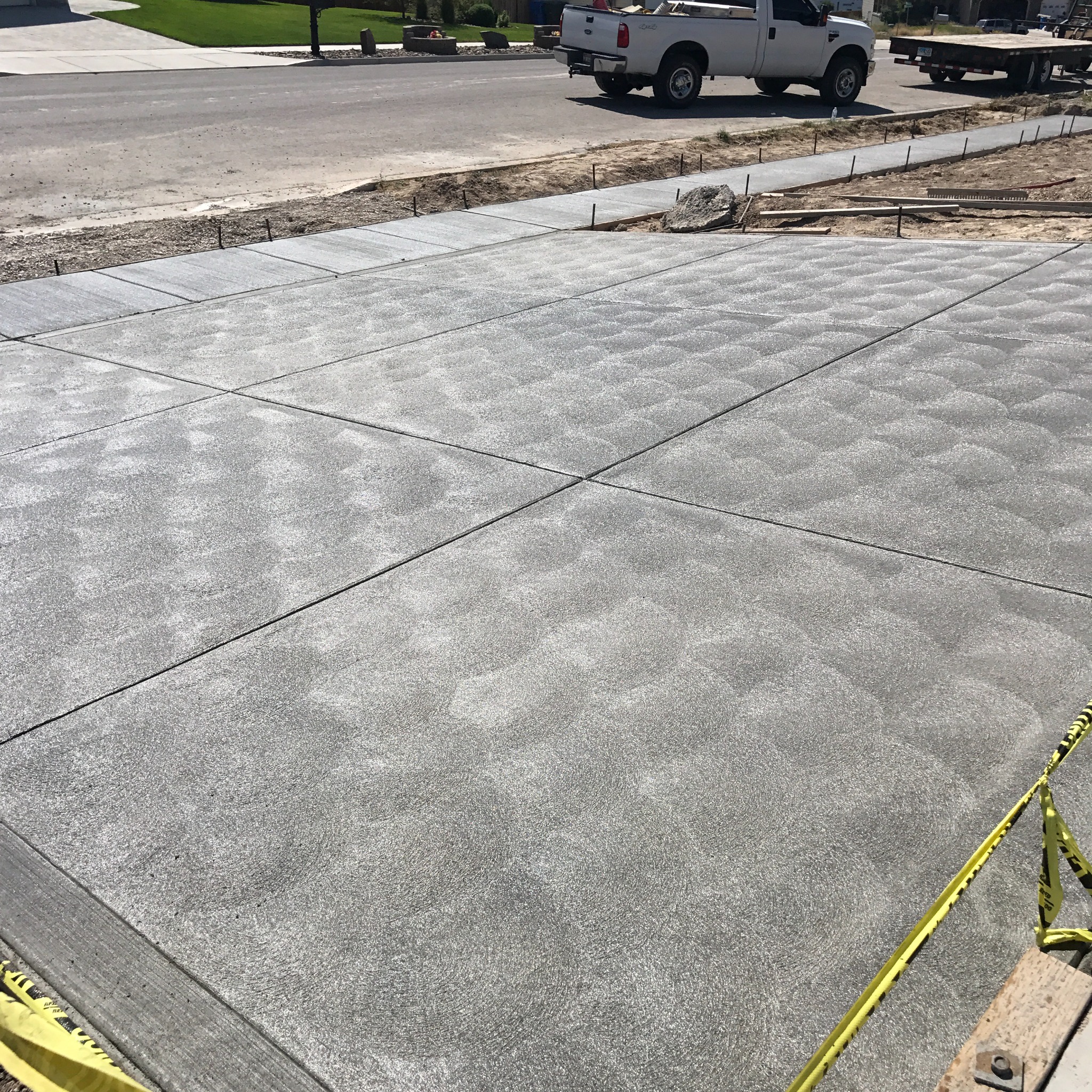Finished concrete driveway with clean broom finish